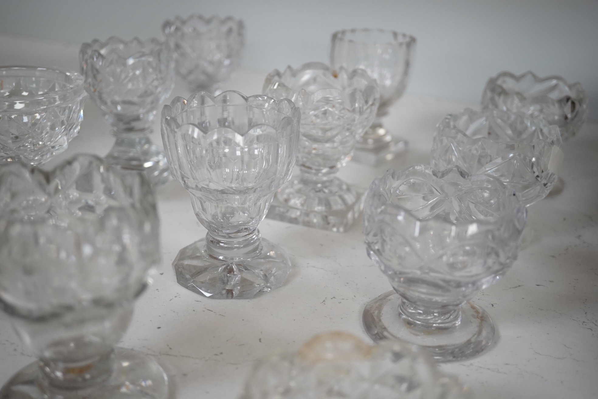 A group of twelve Georgian cut glass salts, tallest 9cm. Condition - fair to good, some chipping